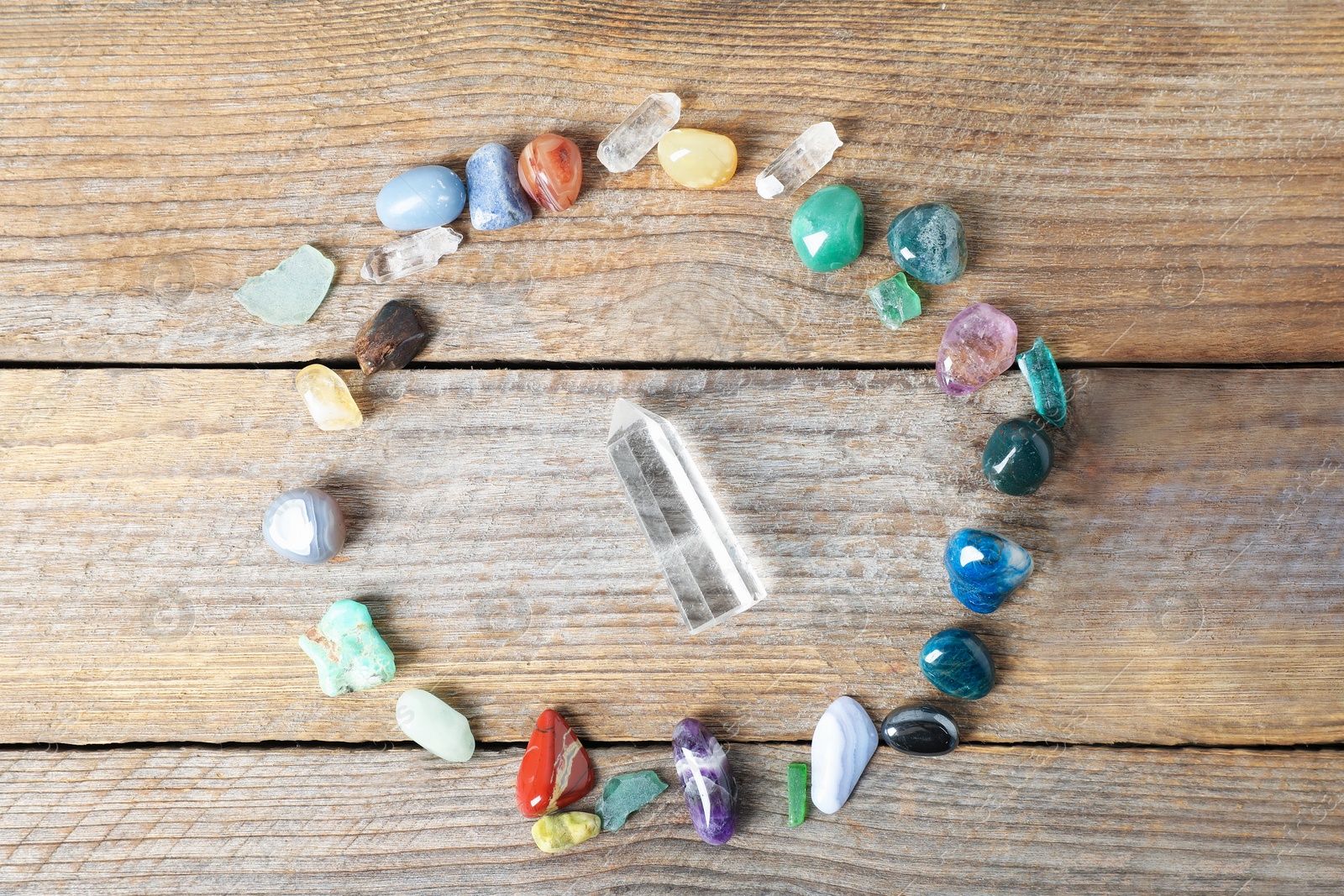 Photo of Aura. Different natural mineral stones on wooden table, flat lay
