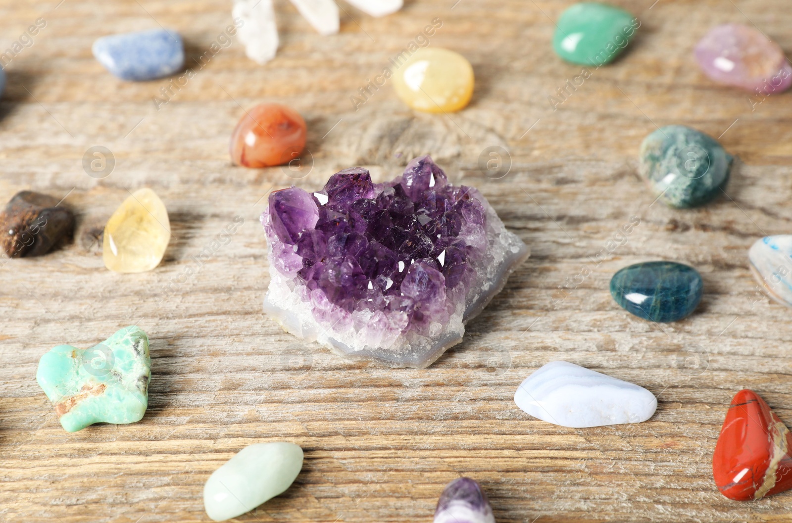 Aura. Different natural mineral stones on wooden table, closeup Photo of Aura. Different natural mineral stones on wooden table, closeup