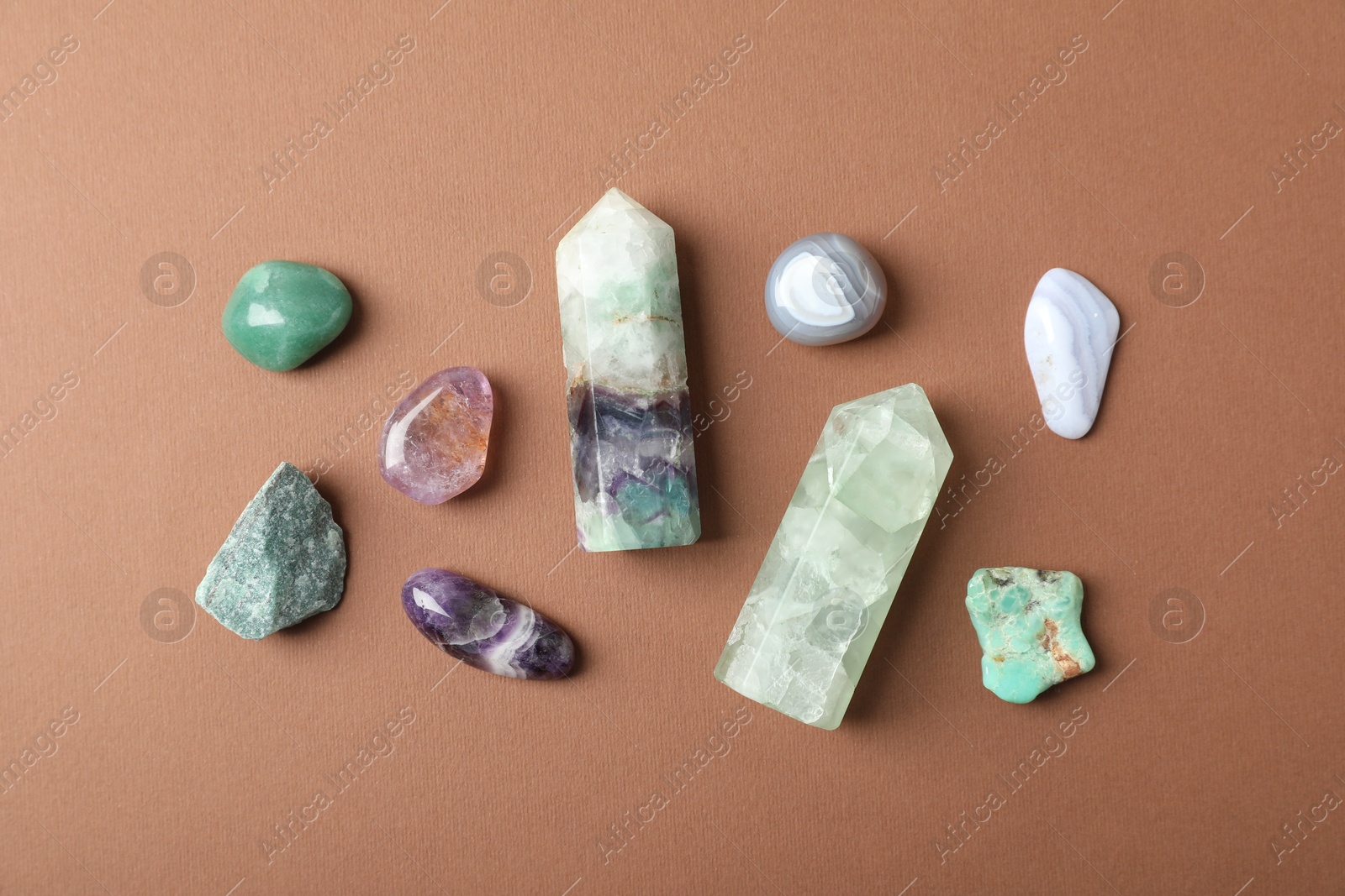 Photo of Aura. Different natural mineral stones on brown background, flat lay
