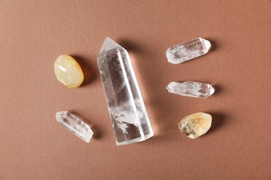 Photo of Aura. Different natural mineral stones on brown background, flat lay