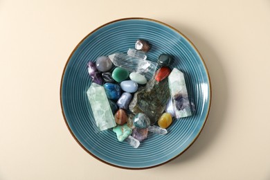 Photo of Aura. Different natural mineral stones on beige background, top view