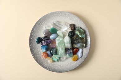 Photo of Aura. Different natural mineral stones on beige background, top view