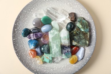 Photo of Aura. Different natural mineral stones on beige background, top view