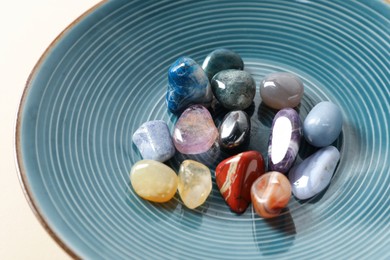 Photo of Aura. Different natural mineral stones on beige background, closeup