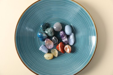 Photo of Aura. Different natural mineral stones on beige background, top view