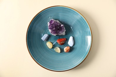 Photo of Aura. Different natural mineral stones on beige background, top view