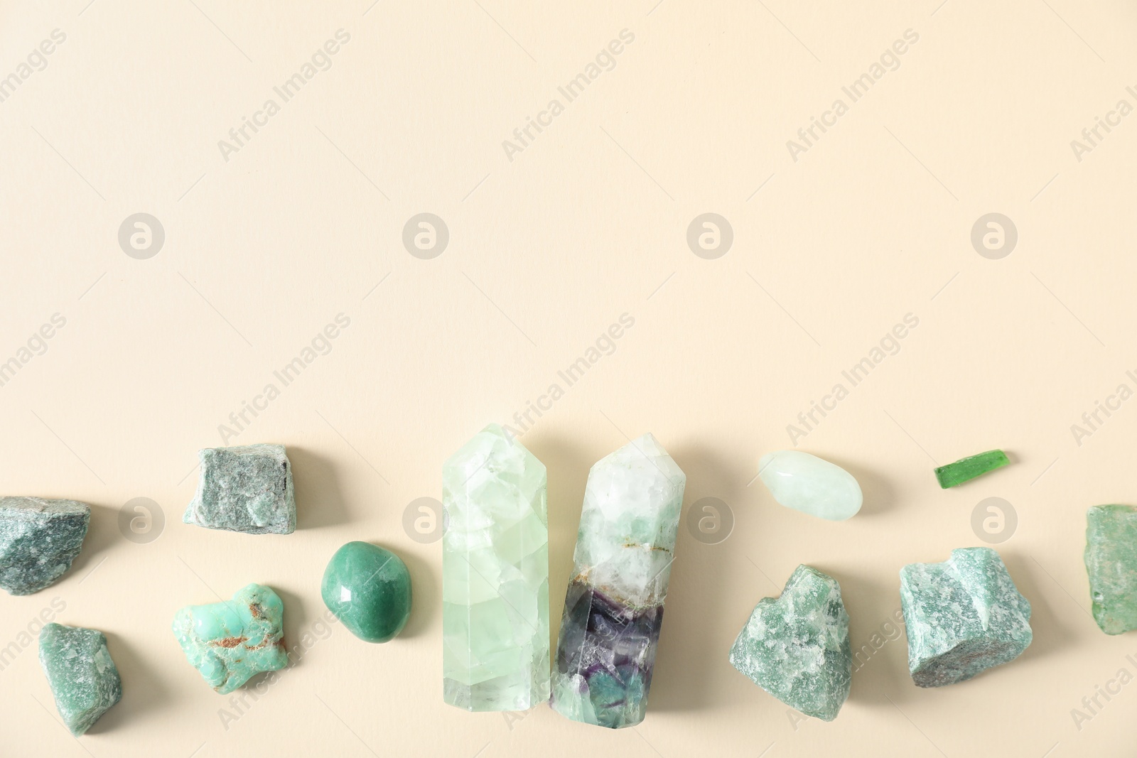 Photo of Aura. Different natural mineral stones on beige background, flat lay. Space for text