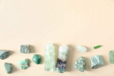 Photo of Aura. Different natural mineral stones on beige background, flat lay. Space for text