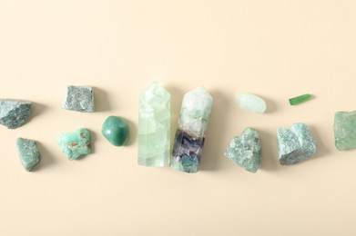 Photo of Aura. Different natural mineral stones on beige background, flat lay