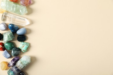 Photo of Aura. Different natural mineral stones on beige background, flat lay. Space for text