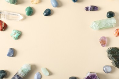 Photo of Aura. Different natural mineral stones on beige background, flat lay. Space for text