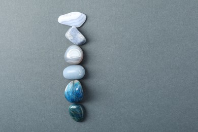 Photo of Aura. Different natural mineral stones on grey background, flat lay. Space for text