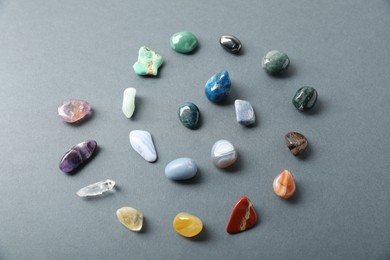 Photo of Aura. Different natural mineral stones on grey background, above view