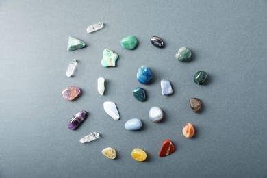 Photo of Aura. Different natural mineral stones on grey background, flat lay