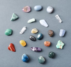 Photo of Aura. Different natural mineral stones on grey background, flat lay