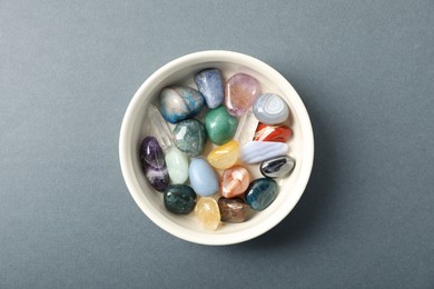 Photo of Aura. Different natural mineral stones on grey background, top view