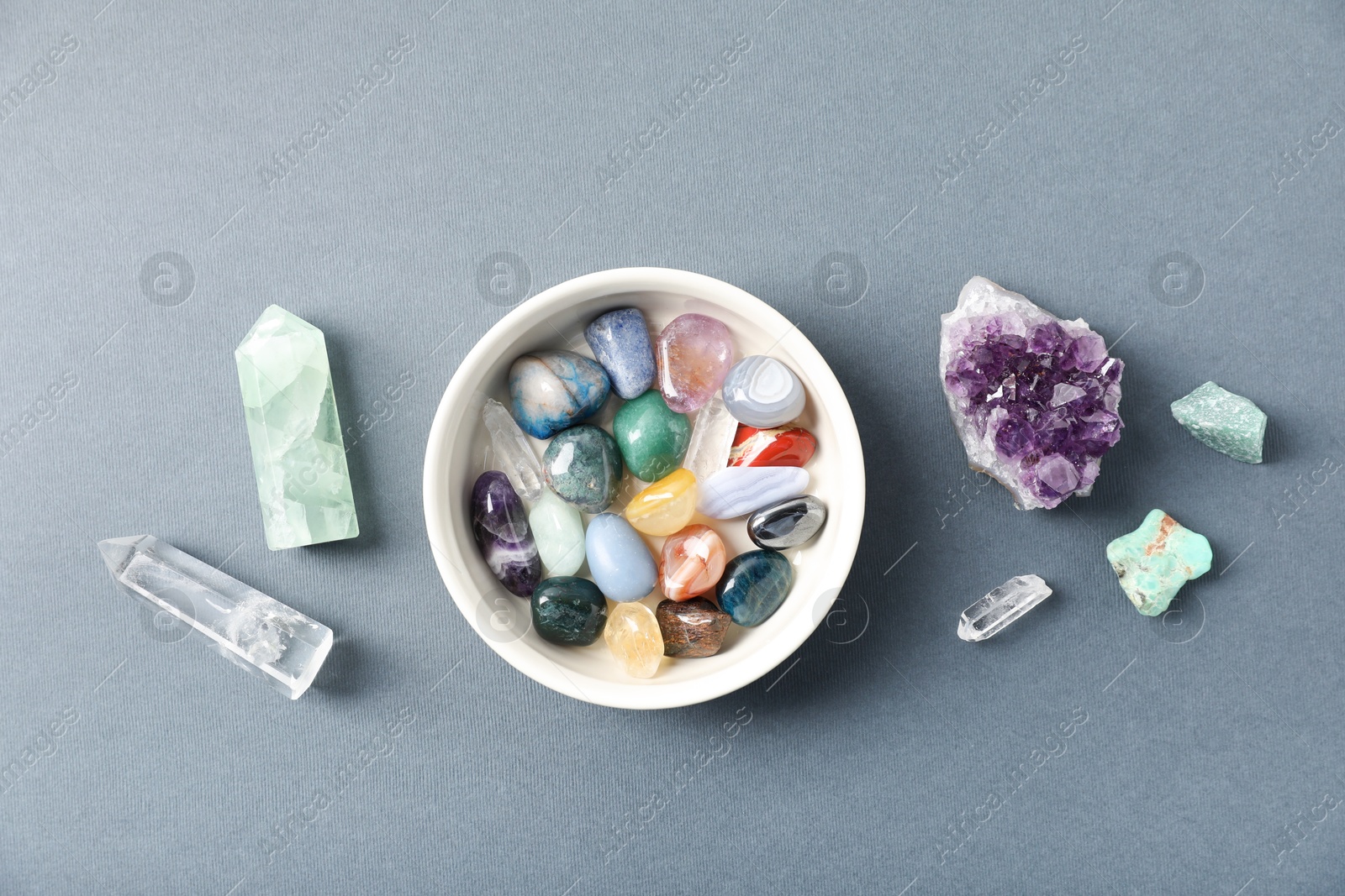 Photo of Aura. Different natural mineral stones on grey background, flat lay