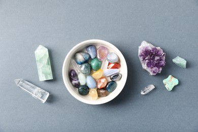 Photo of Aura. Different natural mineral stones on grey background, flat lay