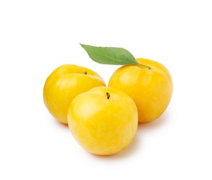 Photo of Whole ripe yellow cherry plums with leaf isolated on white