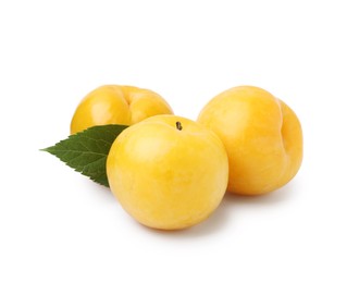 Photo of Whole ripe yellow cherry plums with leaf isolated on white