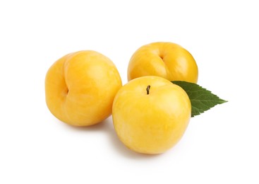 Photo of Whole ripe yellow cherry plums with leaf isolated on white