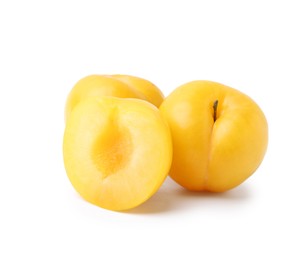 Photo of Whole and cut yellow cherry plums isolated on white