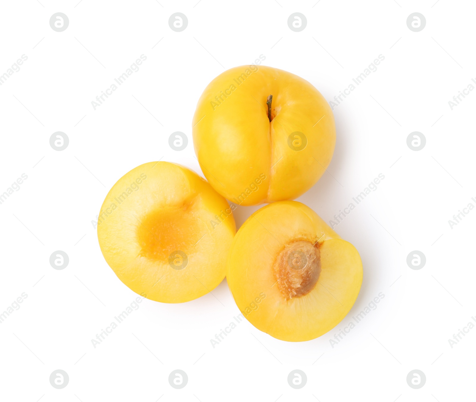 Whole and cut yellow cherry plums isolated on white, top view Photo of Whole and cut yellow cherry plums isolated on white, top view