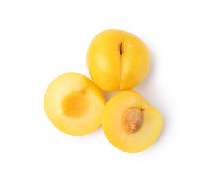 Photo of Whole and cut yellow cherry plums isolated on white, top view
