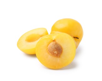 Photo of Whole and cut yellow cherry plums isolated on white