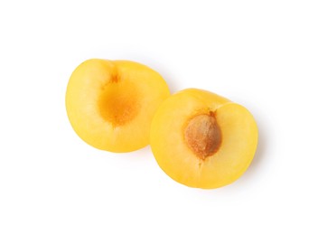 Photo of Halves of yellow cherry plum isolated on white, top view