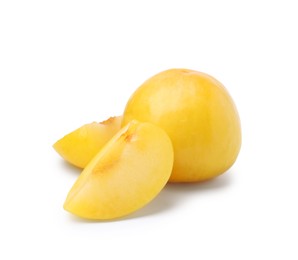 Photo of Whole and cut yellow cherry plums isolated on white