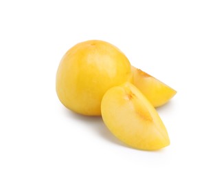 Photo of Whole and cut yellow cherry plums isolated on white