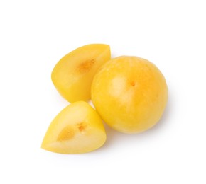 Photo of Whole and cut yellow cherry plums isolated on white, top view