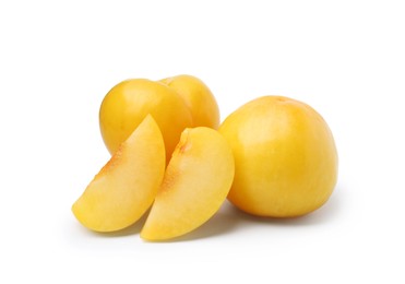 Photo of Whole and cut yellow cherry plums isolated on white
