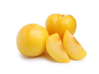 Photo of Whole and cut yellow cherry plums isolated on white