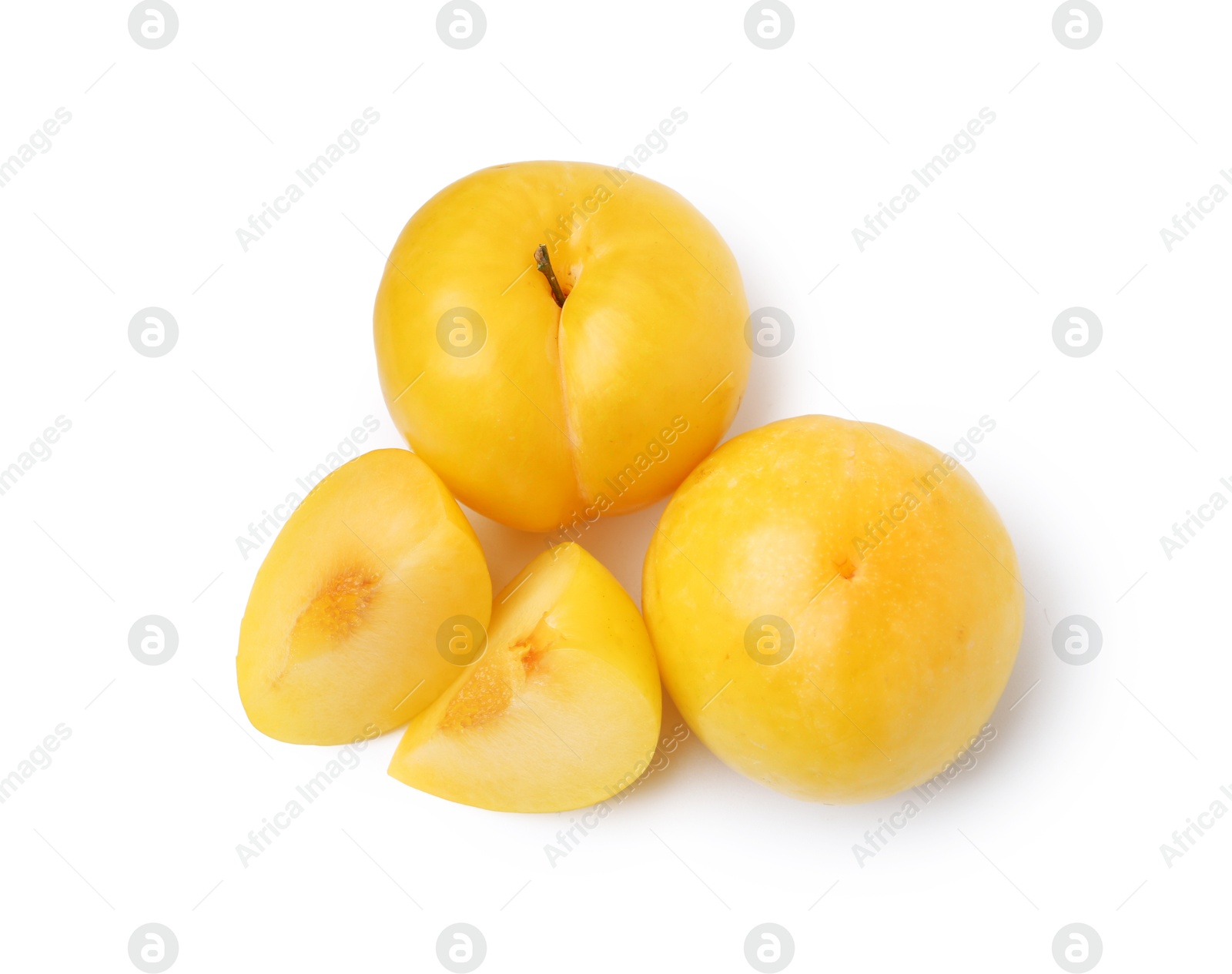 Whole and cut yellow cherry plums isolated on white, top view Photo of Whole and cut yellow cherry plums isolated on white, top view