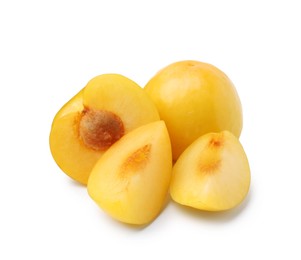 Photo of Whole and cut yellow cherry plums isolated on white