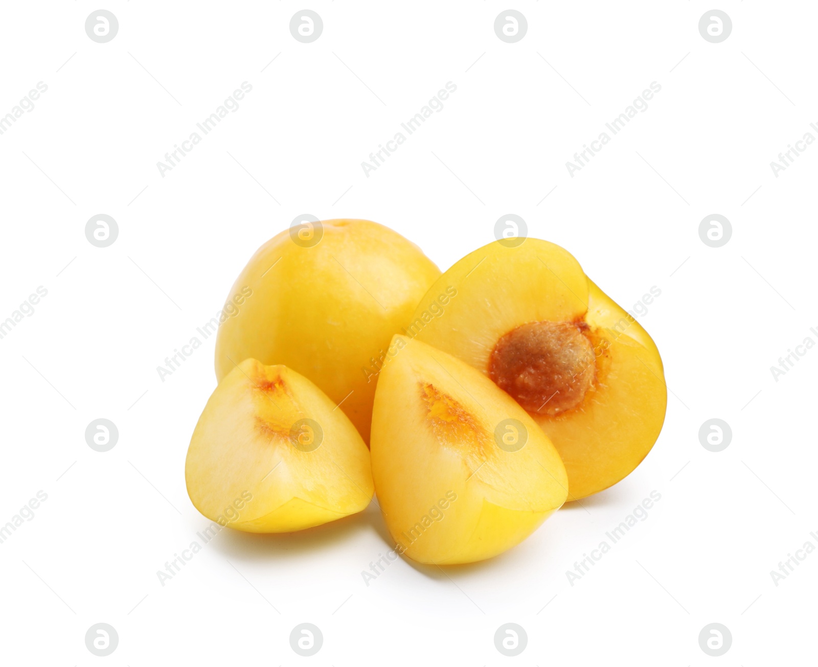 Whole and cut yellow cherry plums isolated on white Photo of Whole and cut yellow cherry plums isolated on white