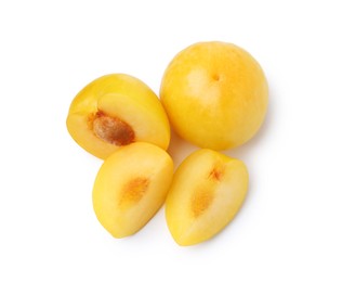 Photo of Whole and cut yellow cherry plums isolated on white, top view