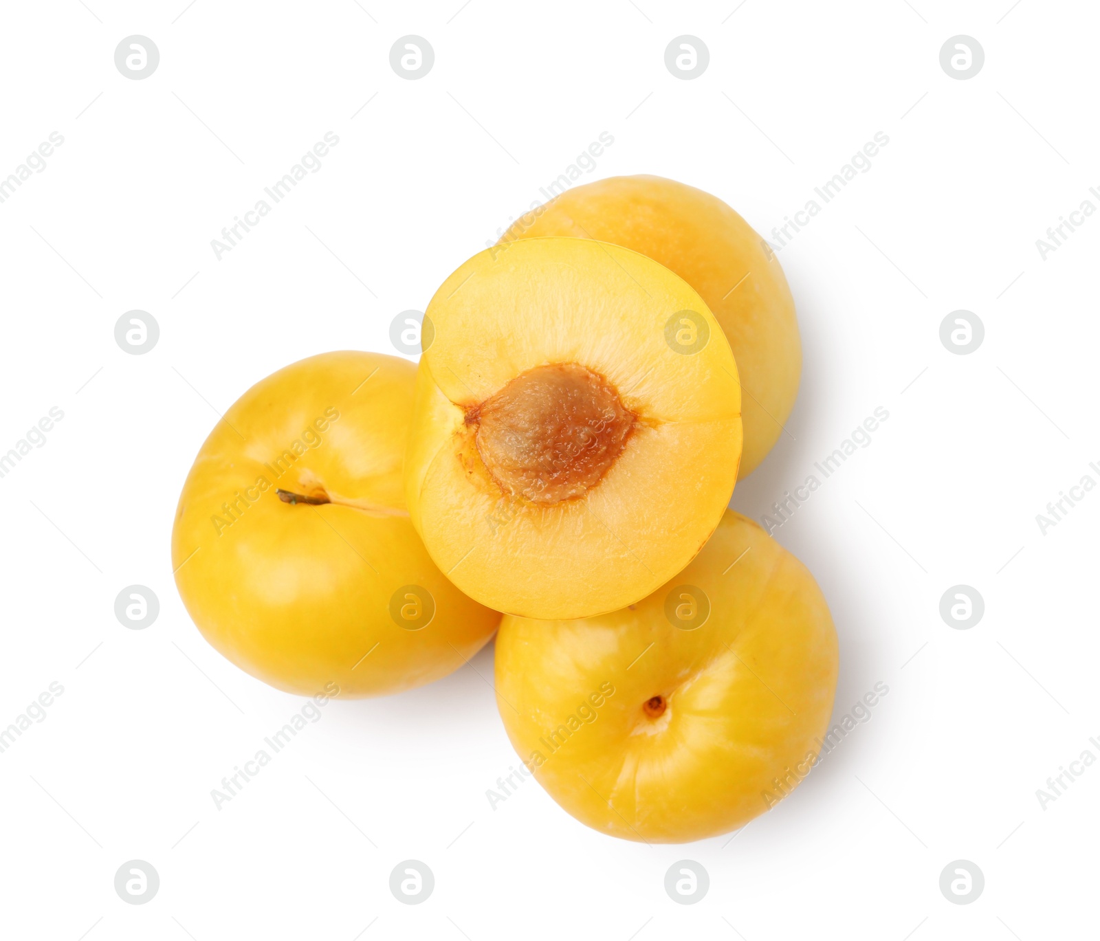 Whole and cut yellow cherry plums isolated on white, top view Photo of Whole and cut yellow cherry plums isolated on white, top view