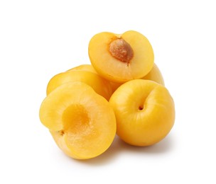 Photo of Whole and cut yellow cherry plums isolated on white