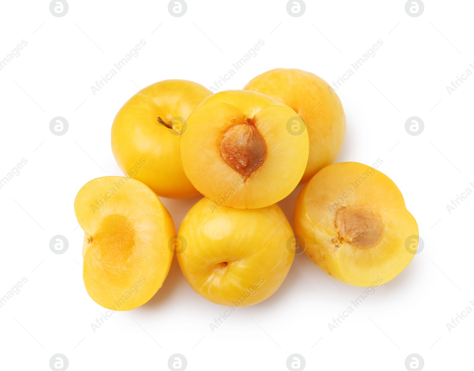 Whole and cut yellow cherry plums isolated on white, top view Photo of Whole and cut yellow cherry plums isolated on white, top view