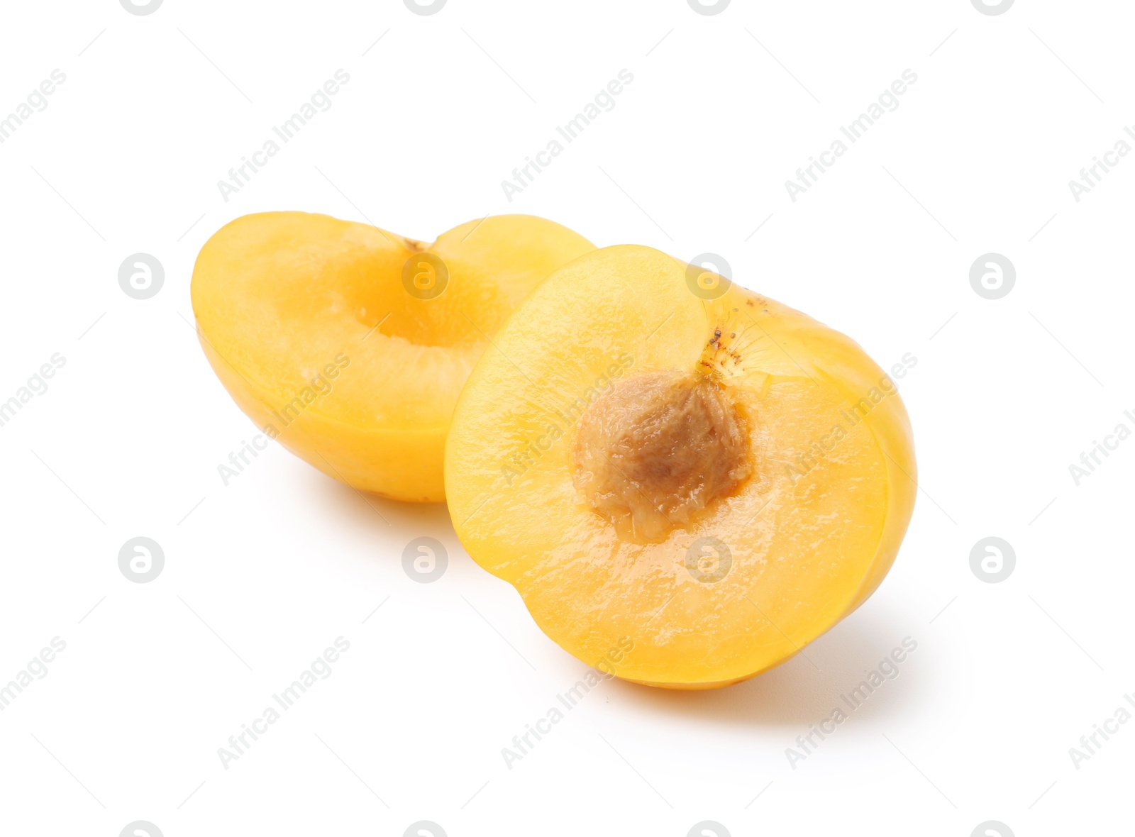 Halves of yellow cherry plum isolated on white Photo of Halves of yellow cherry plum isolated on white