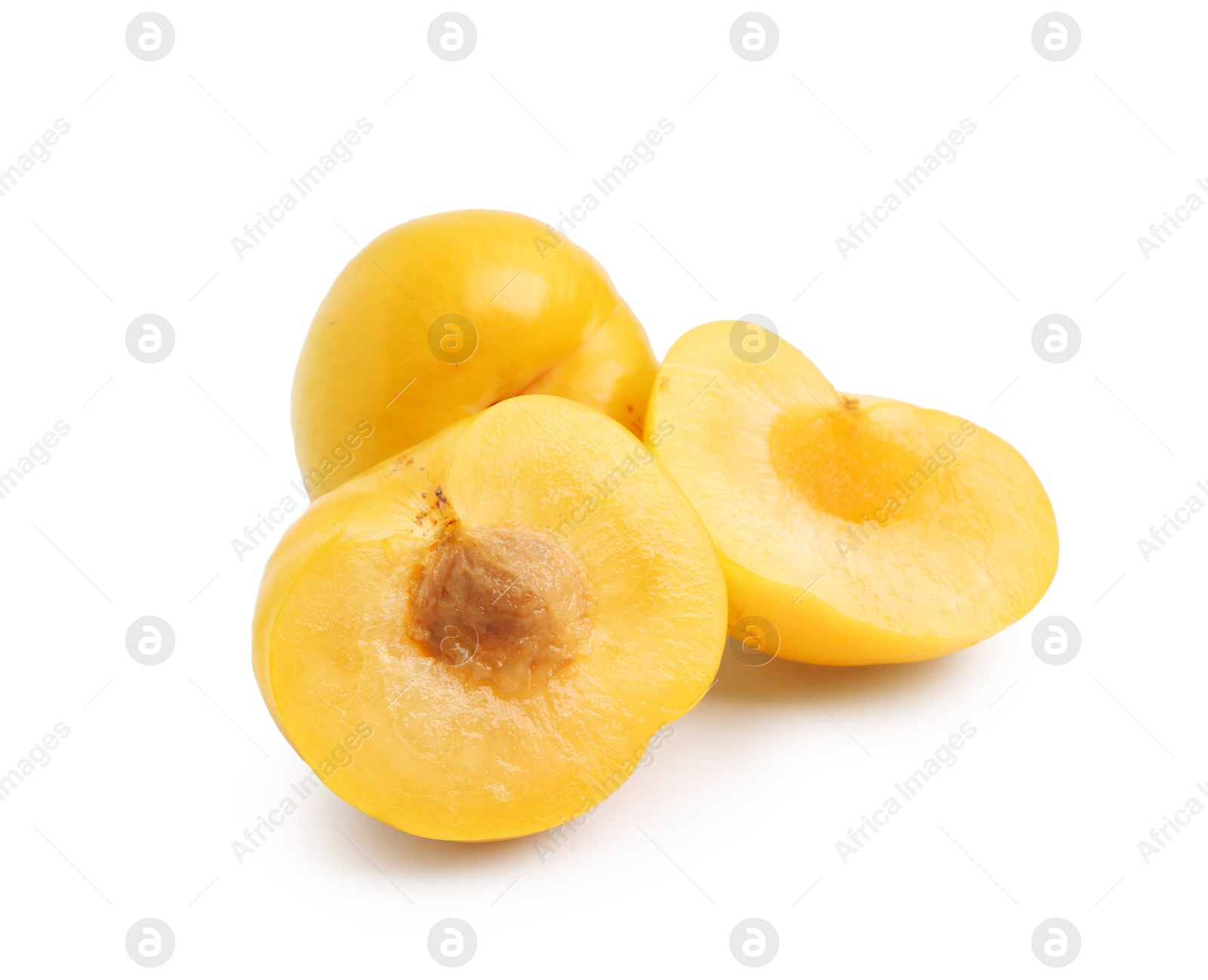 Whole and cut yellow cherry plums isolated on white Photo of Whole and cut yellow cherry plums isolated on white