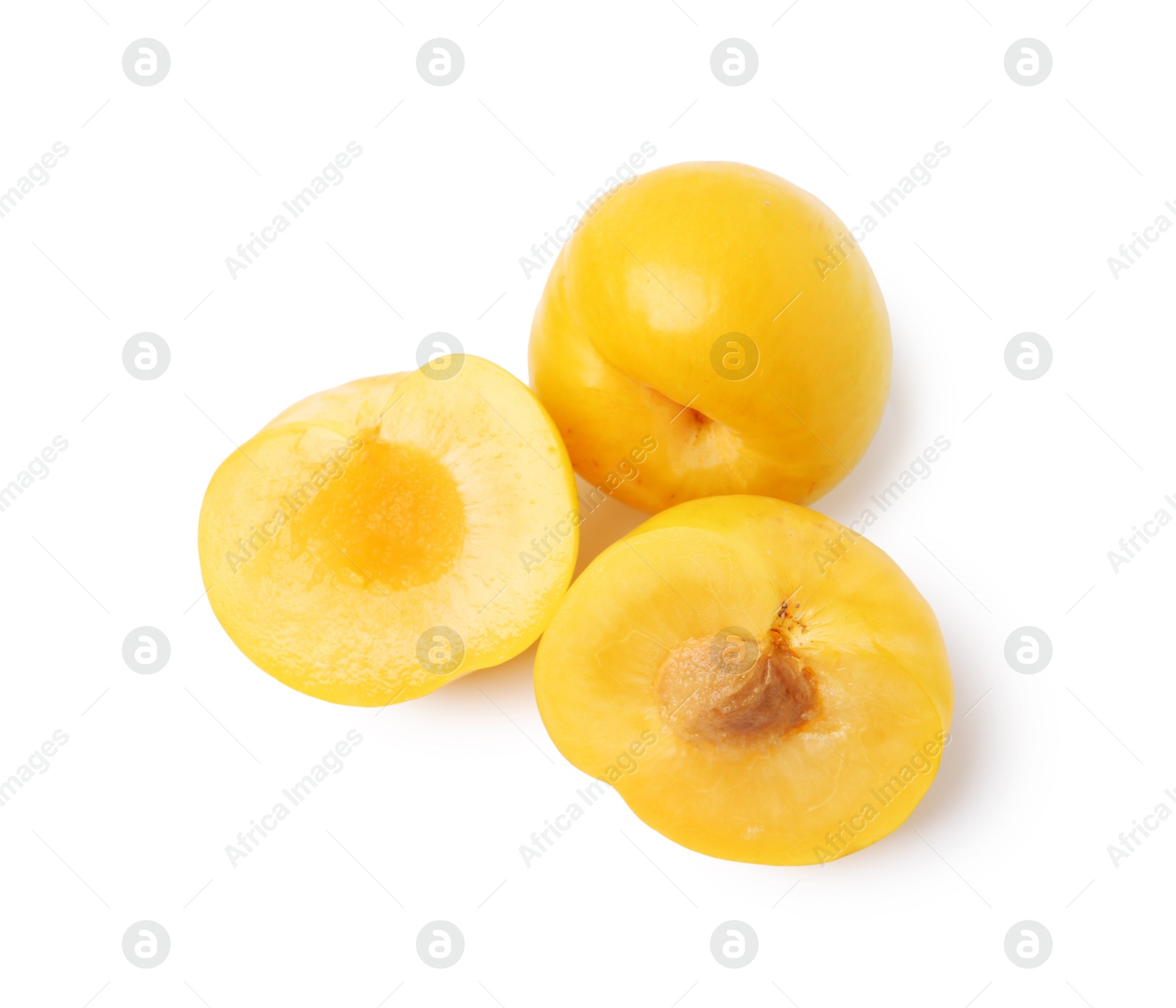 Whole and cut yellow cherry plums isolated on white, top view Photo of Whole and cut yellow cherry plums isolated on white, top view