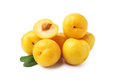 Photo of Whole and cut yellow cherry plums with leaves isolated on white