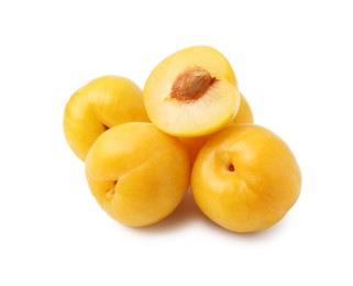 Photo of Whole and cut yellow cherry plums isolated on white