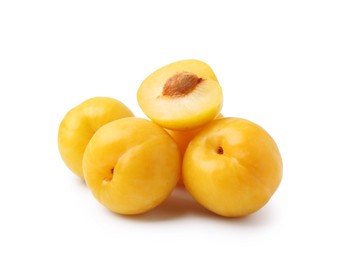 Photo of Whole and cut yellow cherry plums isolated on white