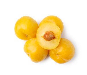 Photo of Whole and cut yellow cherry plums isolated on white, top view