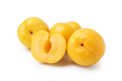 Photo of Whole and cut yellow cherry plums isolated on white